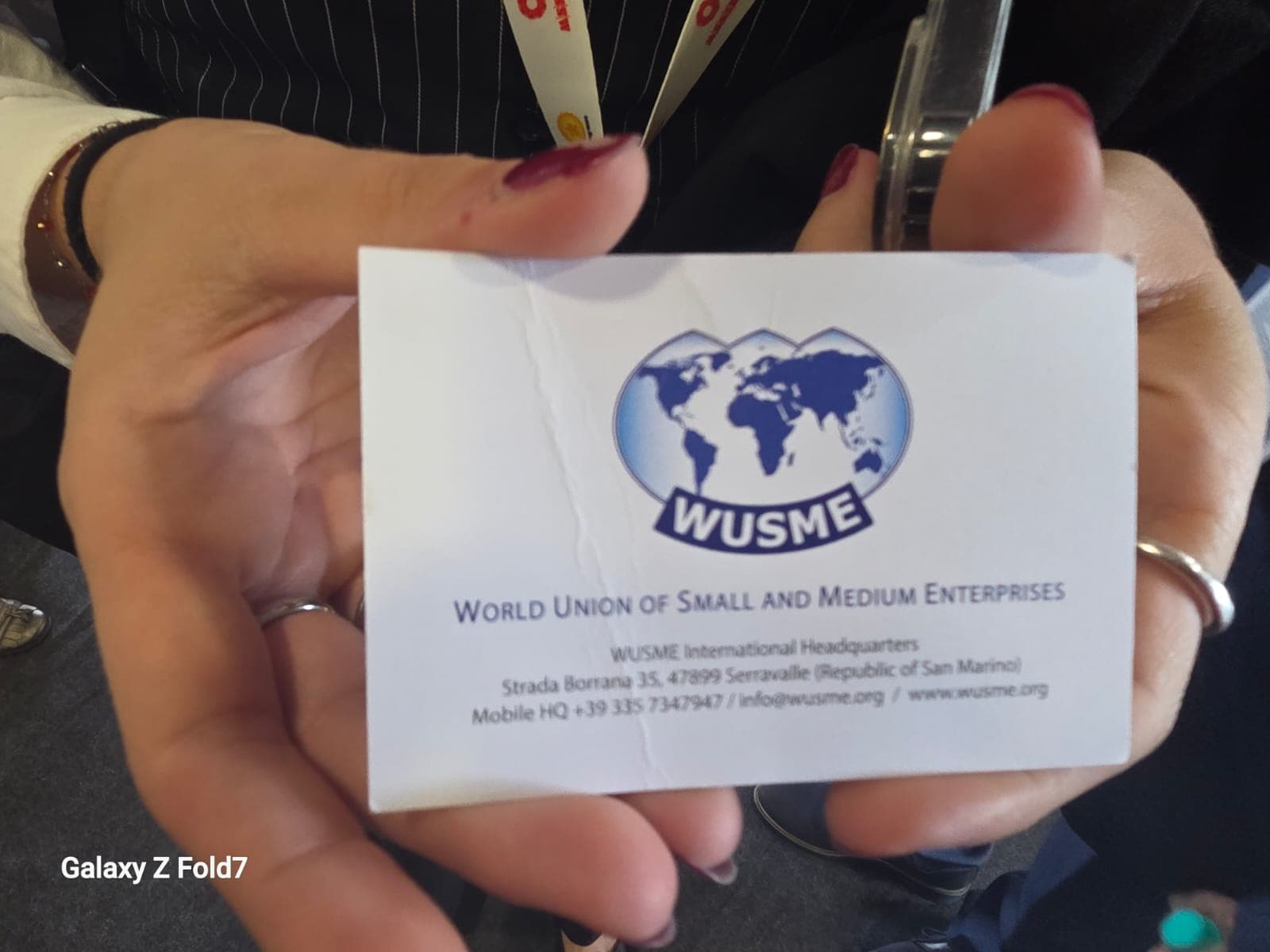 a woman holding up a business card